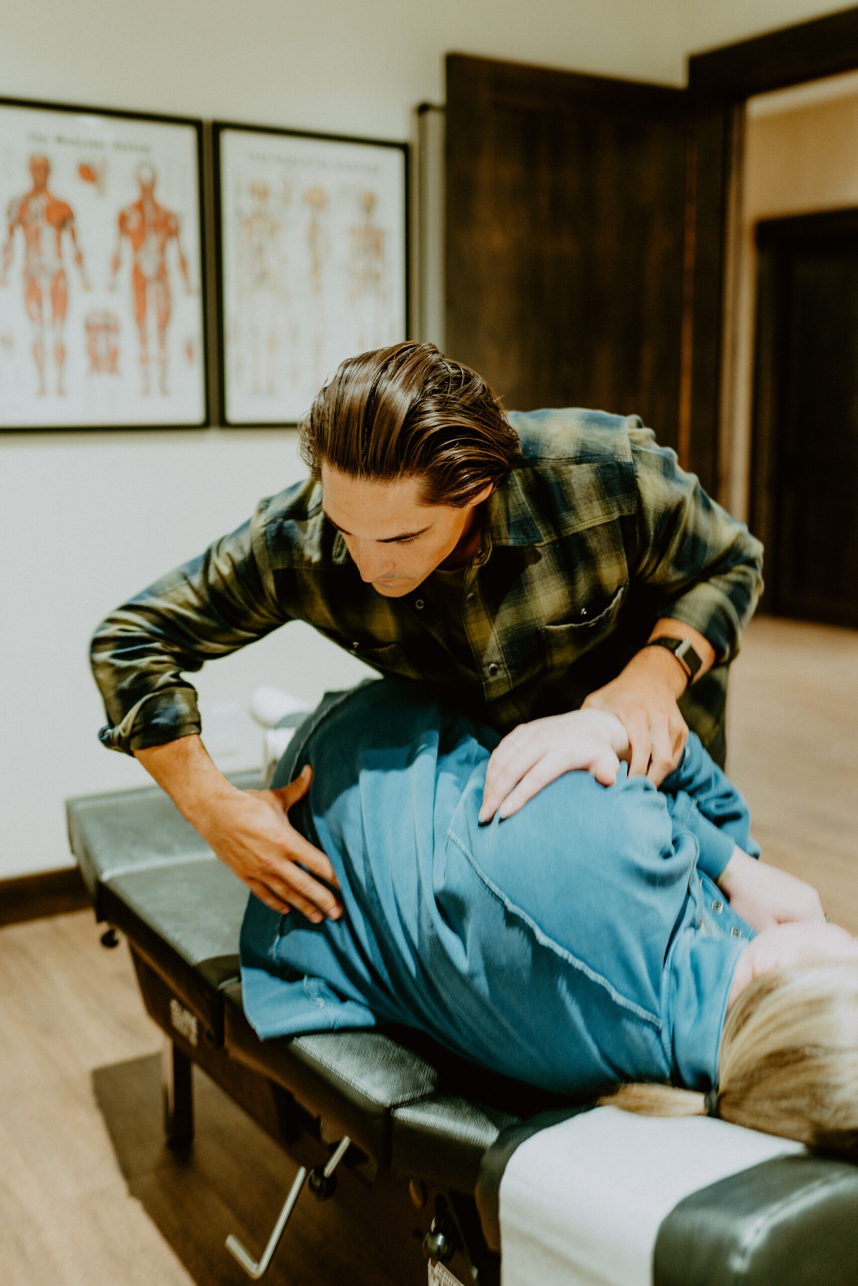 Dr. Kyle DeLamielleure providing a hands-on chiropractic adjustment in the clinic